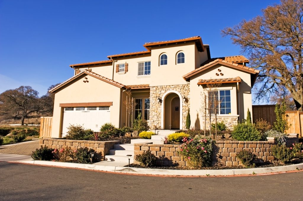 These homes often have a low-pitched roof, little or no eave overhang, a red tiled roof, a prominent arch over the front door, window, or porch, stucco wall surfaces and asymmetrical façades.