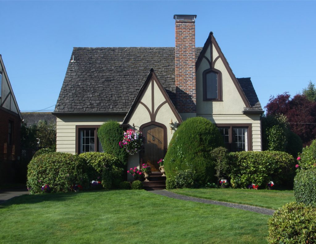 Tudors have decorative half-timbering on bay windows and upper floors, and steep cross gables. They often have tall, narrow windows with small window panes. Large chimneys with decorative chimney pots are also common.