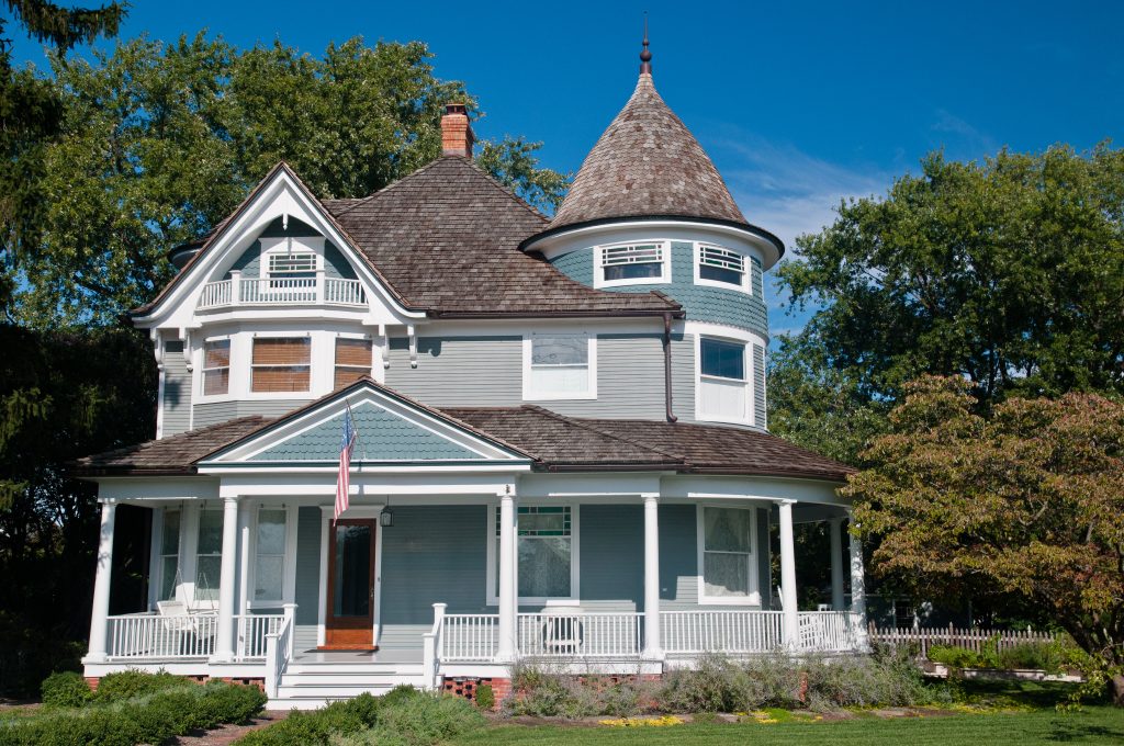 Victorian style architecture includes decorative details such as patterned shingles, curved towers, and spindled porches.